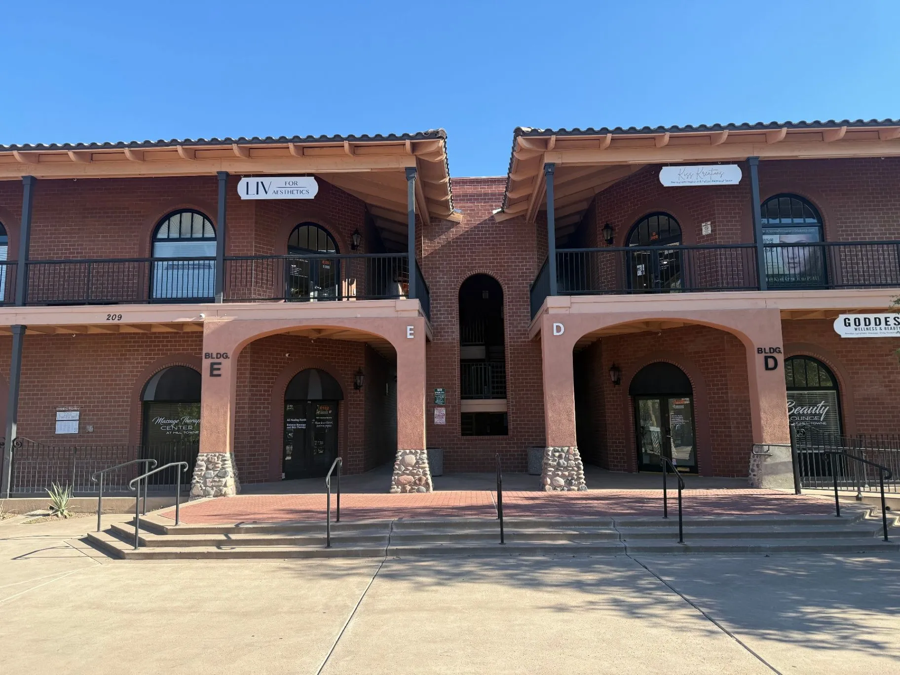 Brick storefronts and covered walkways at Mill Towne Center plaza in Tempe